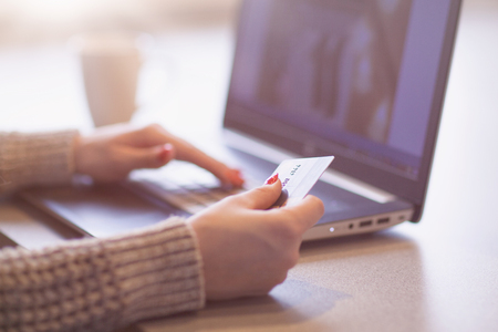 Woman hands holding credit card and using laptop. On line shoppingの写真素材