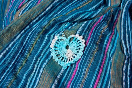 openwork heart on a blue striped fabric called sirsaker の写真素材