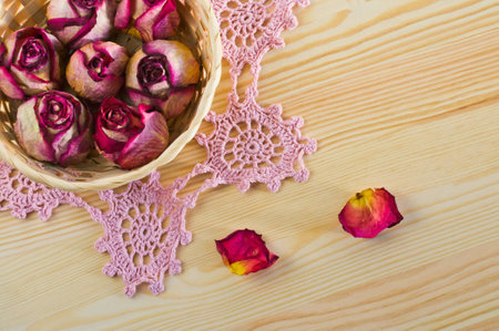 lovely dried roses on the table with light woodの写真素材