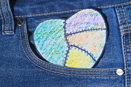 painted heart paper in jeans pocketの写真素材