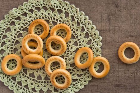 traditional bagels and lace doily on a wooden tableの写真素材