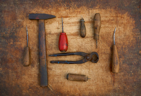 set of vintage shoe tools on a wooden desk
