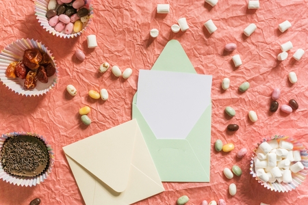 Holiday decorations on a coral background. Party invitation. Flat lay, top view, copy space.の写真素材