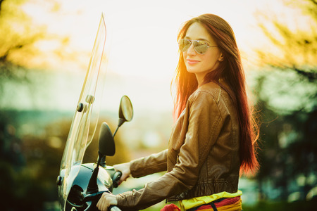 Young beautiful woman on motorcycleの写真素材