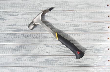 Hammer of carpenter or roofer on grey wooden backgroundの写真素材