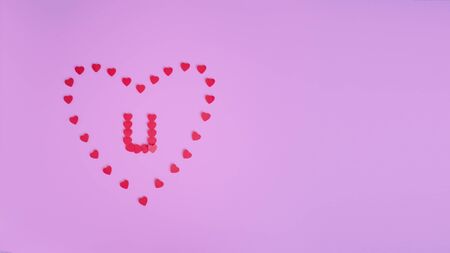 Letter U in center of heart,made of hearts on pink backdrop.Declaration of loveの写真素材