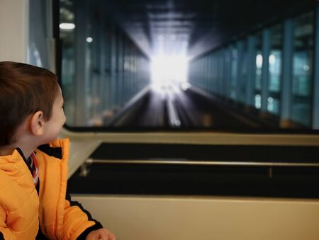 Little boy rides a train between terminals at Frankfurt am Main airport,Germanyの写真素材