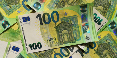 Closeup top view of pile of 100 Euro banknotes scattered across surface. Photo for background....