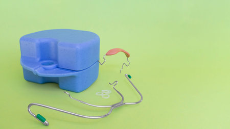 Orthodontic devices: removable metal braces,rubberized flesh-colored plastic cap,-for upper and...