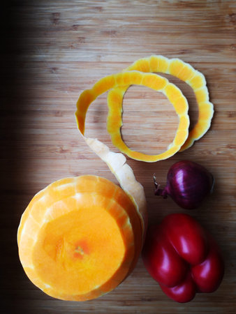 Food still life of Butternut squash,skin in music note shape,red onion,paprika