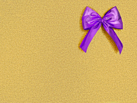 Violet bow,purple ribbon in upper corner,rectangle shiny shimmering golden sequined background,copy space.Promotion decor.We purple you.Korean K-pop symbol color.Christmas,New Year,birthday patternの写真素材