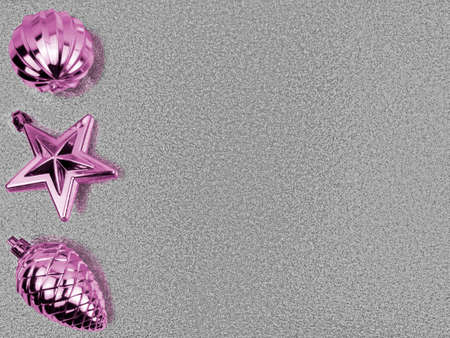 Top view three purple Christmas tree toys,ball with edges,star,fir cone on left side,shiny shimmering silver backdrop.Christmas,New Year,birthday metal holiday decoration.Horizontal banner,copy spaceの写真素材