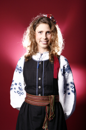 photo in ethnic clothes. The image of a young girl in a shirt that is embroidered with blue threads.の写真素材