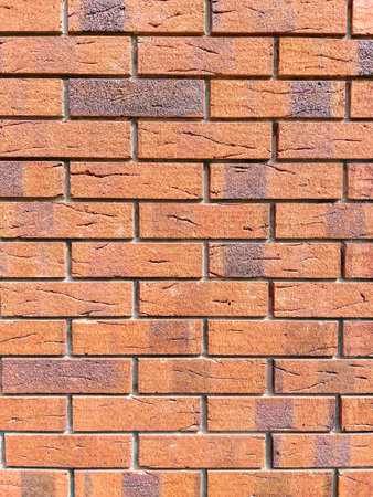 Brick wall background. Decorative brickwork from a smooth new brick. Copy space on the background of...