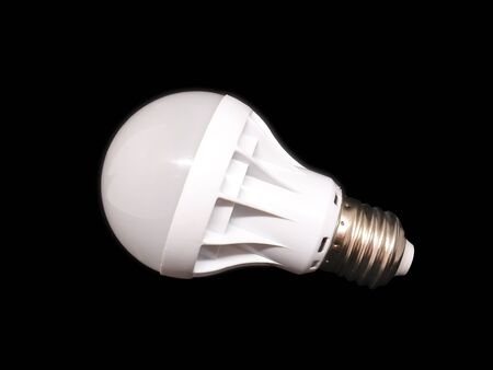 White LED lamp, isolate on a black background. Concept: environmental friendliness, energy saving, modern technologies.の写真素材