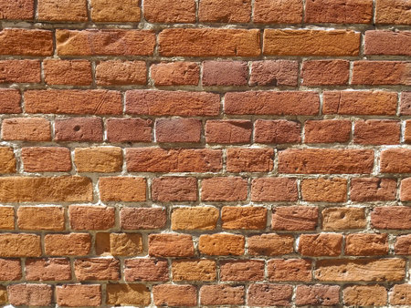 The texture of red antique brick. Background of old red brick wall texture with deterioration from...