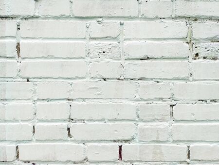 The brick wall is painted with white paint. White brick background. Square orientation. Neutral background, texture of an old white brick wall.の写真素材