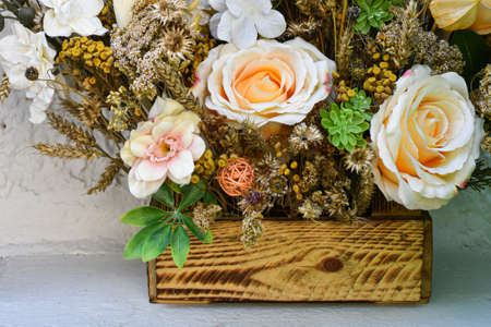 Background, texture of a dried flower. Bouquet of dried flowers in beige tones in a wooden box. Space for text, logo.の写真素材