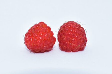 Juicy raspberry berries on a white background. Seasonal summer berry, a source of vitamins. Healthy...