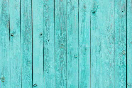 Texture of shabby wooden planks in blue. Peeling paint on wood grain surface. Old wooden background painted in turquoise colors. Wooden background.の写真素材