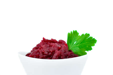 Grated beets. Fresh beet salad in a white bowl isolated on a white background. The concept of healthy food, diet, fresh vegetables, vitamins and liver recovery.の写真素材