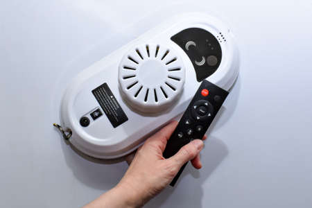 Robot for cleaning windows and tiles with remote control. A device for cleaning windows indoors and outdoors. Appliances. Robot for cleaning flat surfaces. Robot window cleaner.の写真素材