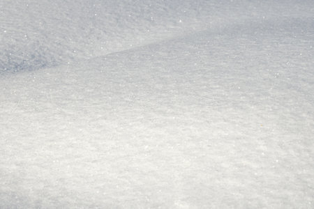 White snow texture on clear day. Winter background. Snow drifts. white snowflakes background, rough pattern of snow textureの写真素材