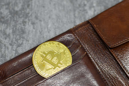 Bitcoin in wallet. There is bitcoin coin in wallet pocket. Crypto currency in your walletの写真素材