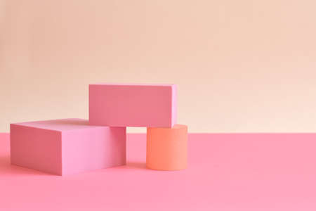 Pink and yellow abstract background with three-dimensional geometric shapes in pastel colors. Selective focus, space for textの写真素材