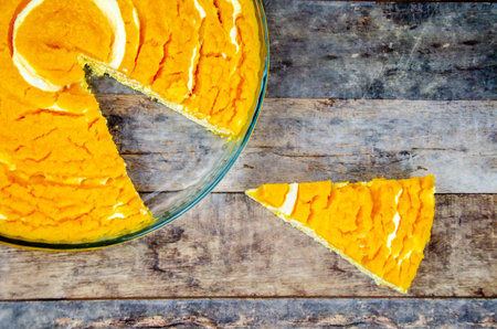 Pumpkin and curd casserole. Slice of pumpkin cheesecake next to platter of sugar-free pie with...
