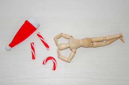 man bent over broken Candy cane in despair. Preparation for Christmas, stress, frustration, failureの写真素材