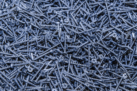 Lots of small black screws. Texture, bunch of screws scattered around. screws texture background