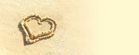 heart is drawn on beach sand. Painted heart on sand. template, banner, text spaceの写真素材