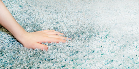 woman chooses carpet. Hand touches soft carpet in a store, close-upの写真素材