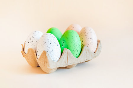 colorful Easter eggs in ecological packaging on beige background. happy Easterの写真素材