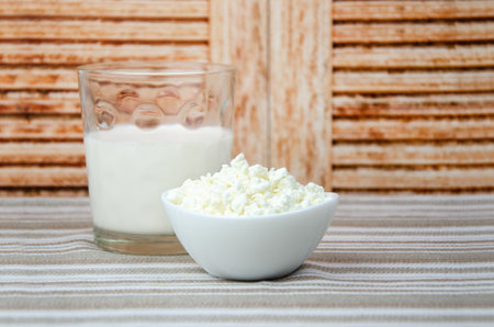 glass of milk, a cup of fresh cottage cheese. Fresh farm dairy products, simple rustic still lifeの写真素材
