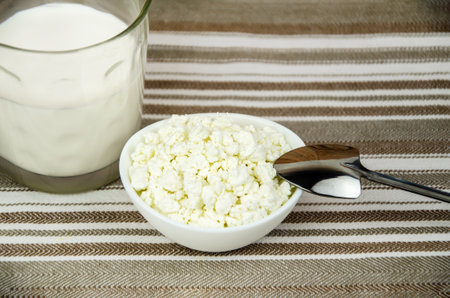 glass of milk, a cup of fresh cottage cheese. Fresh farm dairy products, simple rustic still lifeの写真素材