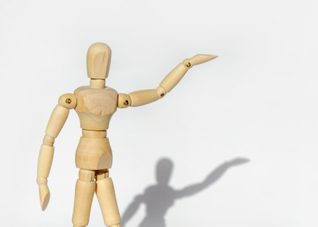 Wooden man on white background shows space for copy and textの写真素材