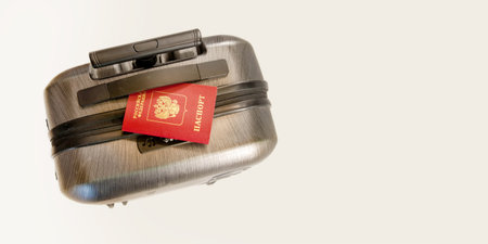 Travel baggage with passport. Russian passport on black suitcase. banner, concept: Travel, vacationの写真素材
