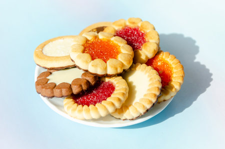cookies on plate against blue background. round cookies laid out on saucer. copy space, top viewの写真素材