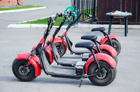 Electric scooters with wide tires for hire in the park. electric two wheeled mini motorcycle for rent.の写真素材