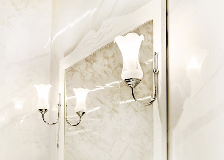 two wall lamps near mirror in the bathroom. Interior details in a classic style.の写真素材
