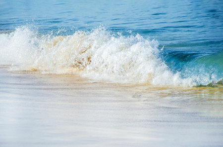 Blue sea wave, white foam, golden sand of sea coast. travel concept, summer vacation, backgroundの写真素材