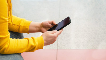 woman uses a smartphone, close-up. Female hands typing a message on a mobile phone
