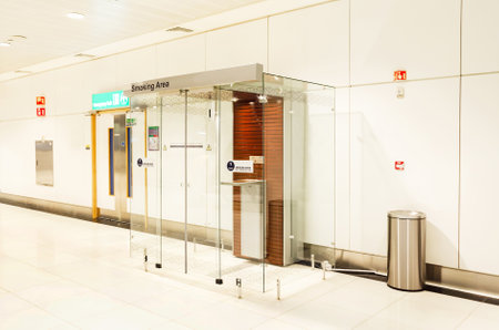 Glass cabin for smoking. isolated room with air conditioning for smoking cigarettes inside airportの写真素材