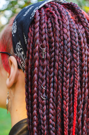 Close-up of the head of a young woman with many of thin African braids, gathered into a hairstyle with a bandana. informal modern styleの写真素材