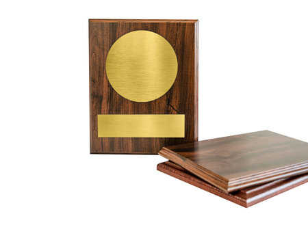 Wooden board with gold plate isolated on white background. plaque with gold overlay for textの写真素材