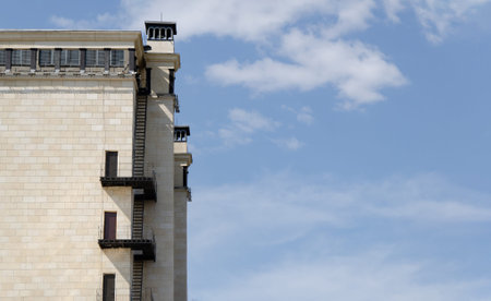 fire escape on high-rise building against background of blue sky. corner of a large buildingの写真素材