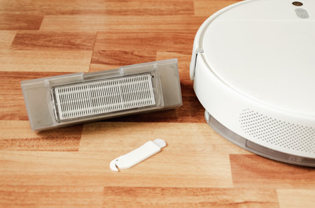 Brush for cleaning filter of dust container in robot vacuum cleaner. Servicing robot vacuum cleanerの写真素材