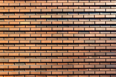 background, texture of red brown brick wall. Facing bricks on the facade of a modern building.